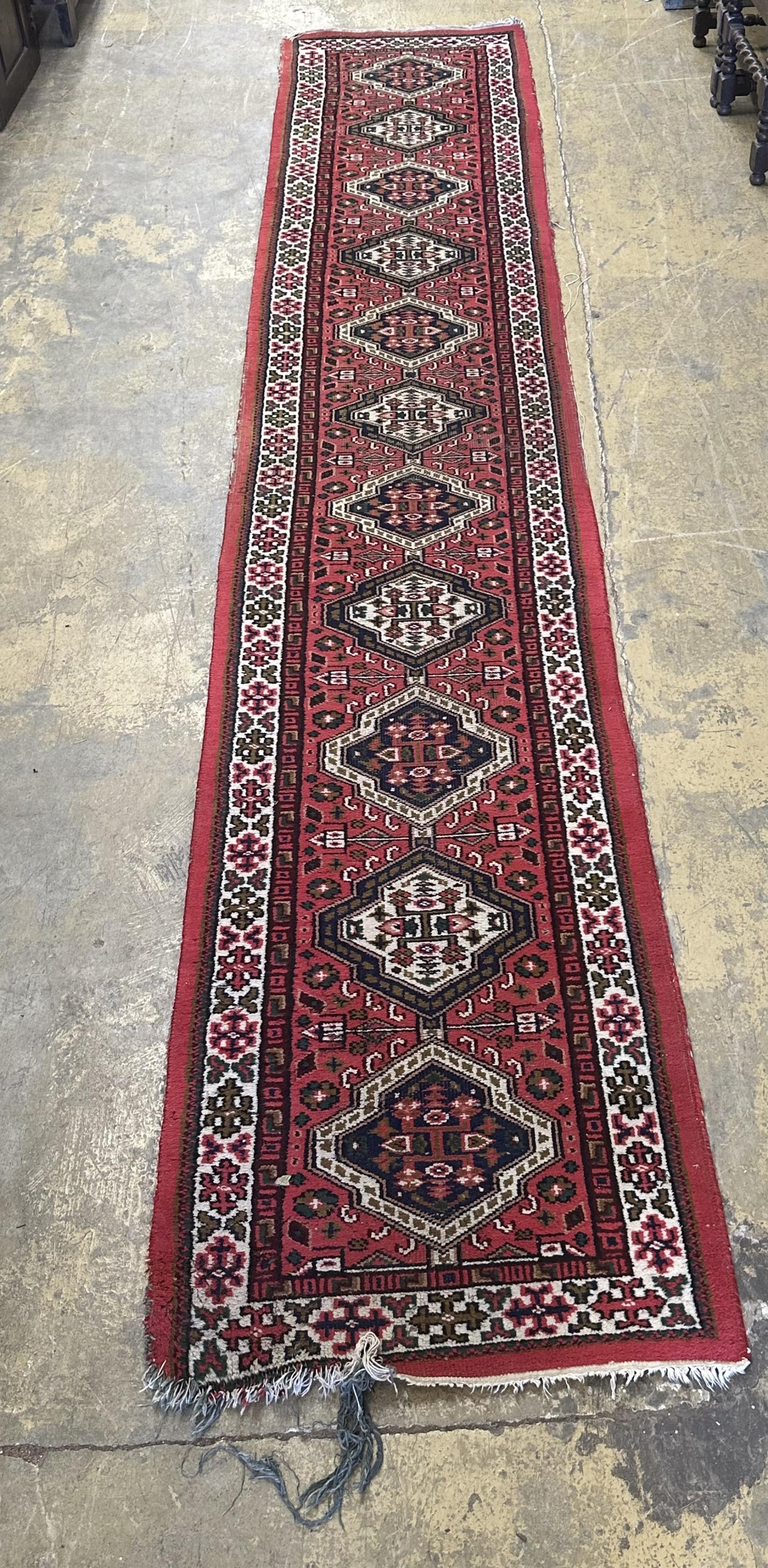 A Caucasian style runner, 430 x 77cm. Condition - poor-fair